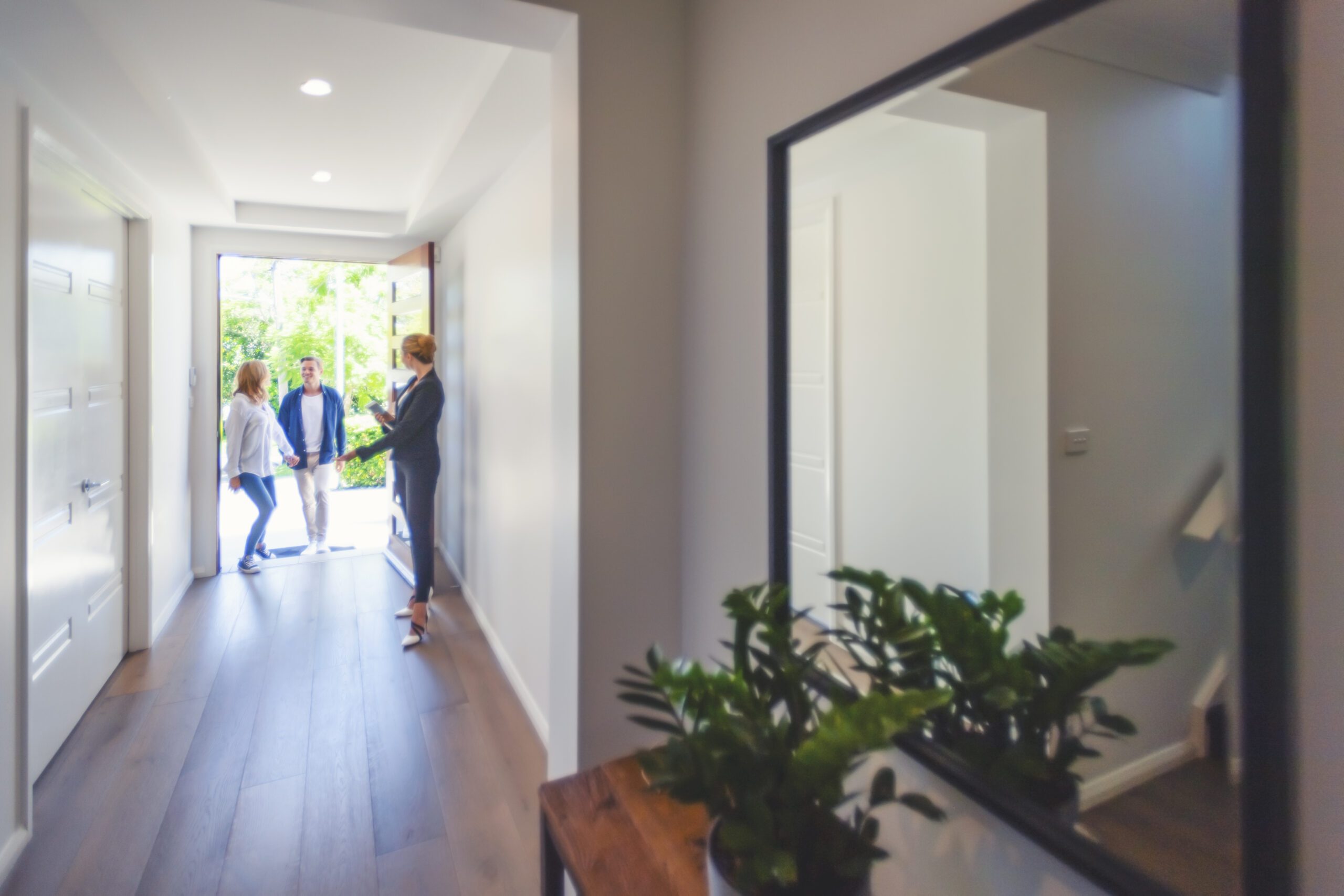 Real estate agent showing a young couple a new house