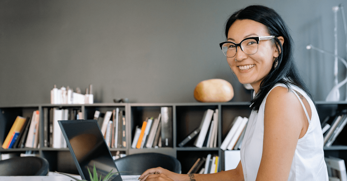 Woman with glasses working on laptop